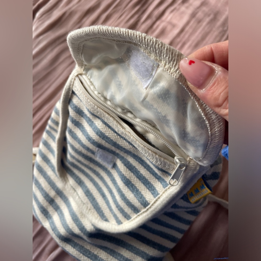 Striped blue and cream backpack with small zip pocket in front. - Picture 4 of 6